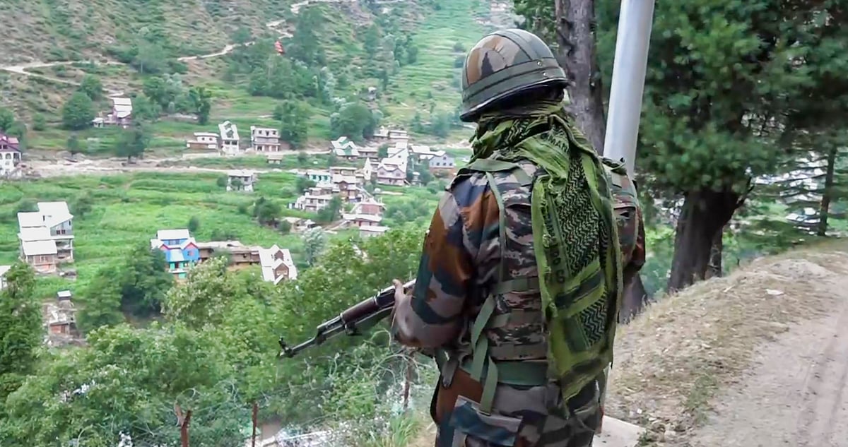 PTI : A security official stands guard amid heavy security near the site of a recent encounter with terrorists at Desa village, in Doda district, Wednesday, July 17, 2024